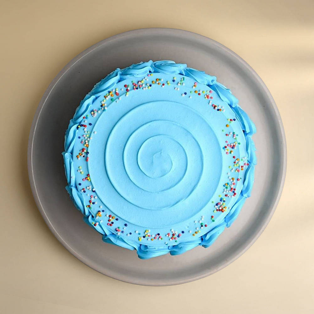 Top View of Blue Sprinkles Frosted Cake