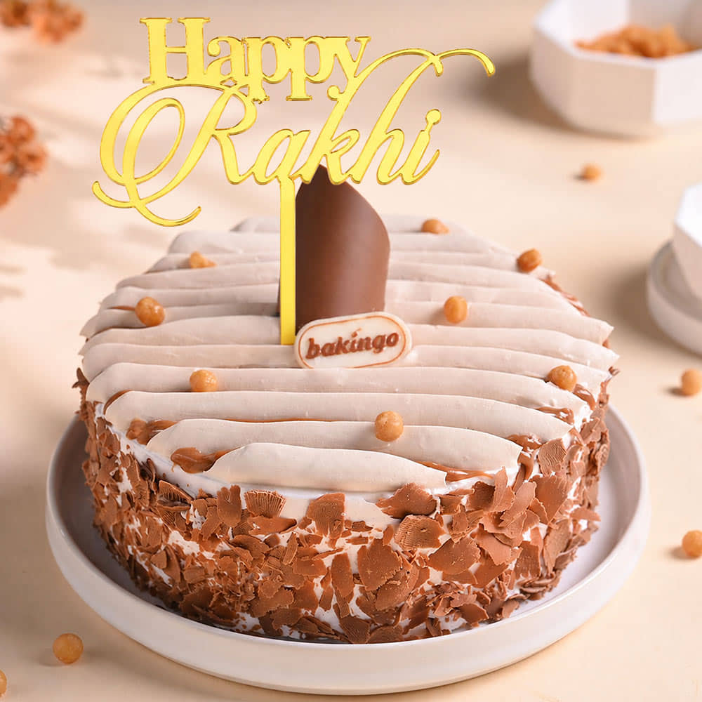 Butterscotch Crunch Cake With Floral Rakhi Front View of Butterscotch Crunch Cake With Floral Rakhi
