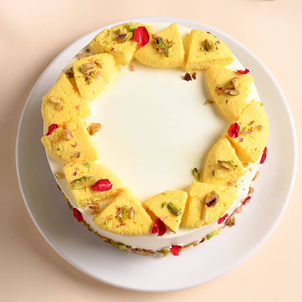 Rasmalai Cake With Two Peacock Designer Rakhis Top View of Rasmalai Cake With Rakhi