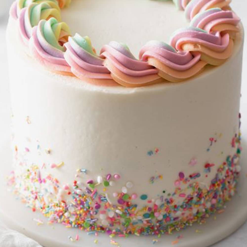 Side View of Dainty Swirly Rainbow Cream Cake