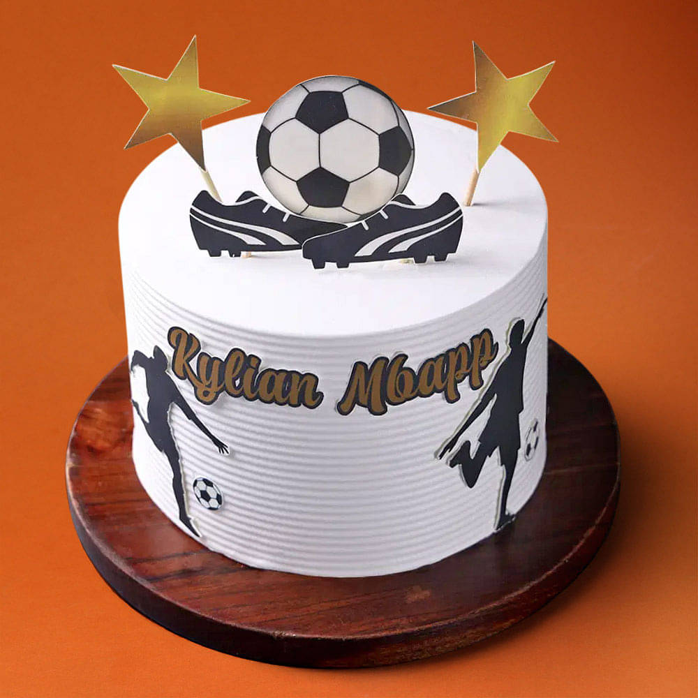 White frosted cake decorated with a soccer theme