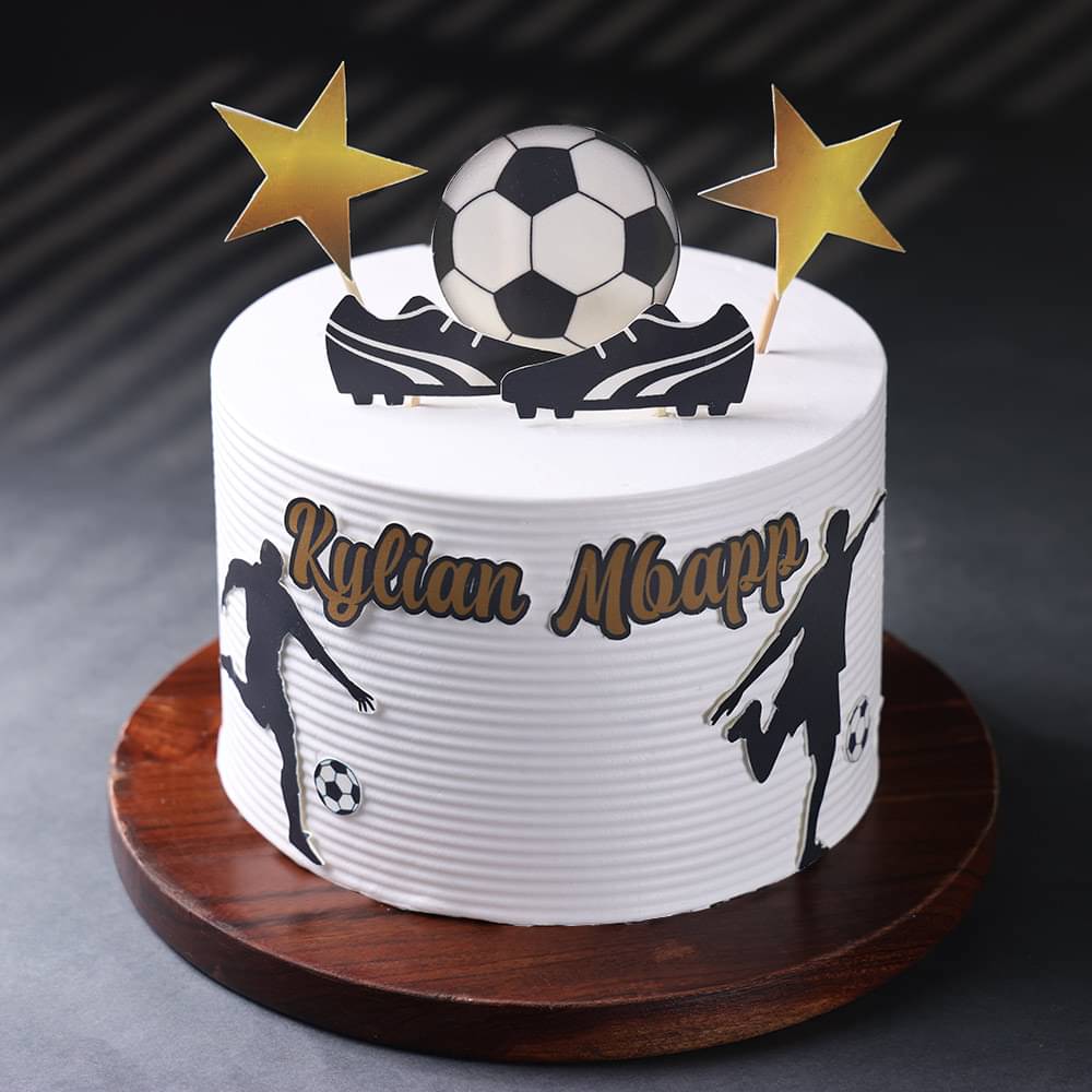 White frosted cake decorated with a soccer theme