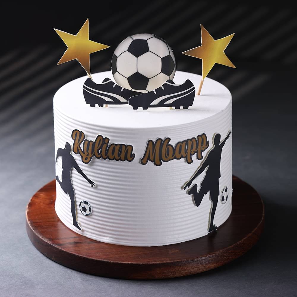 White frosted cake decorated with a soccer theme