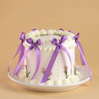 Front Angled View of Floral Swirls Ribbon Cake Front Angled View of Floral Swirls Ribbon Cake
