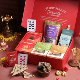 Gourmet Snack Arrangement with Playing Cards and Floral Accents Gourmet Snack Arrangement with Playing Cards and Floral Accents