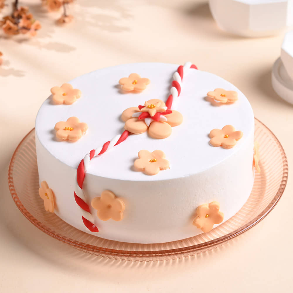 Floral Rakhi Cake With Pearl Rakhi Front View of Pineapple Cake With Rakhi