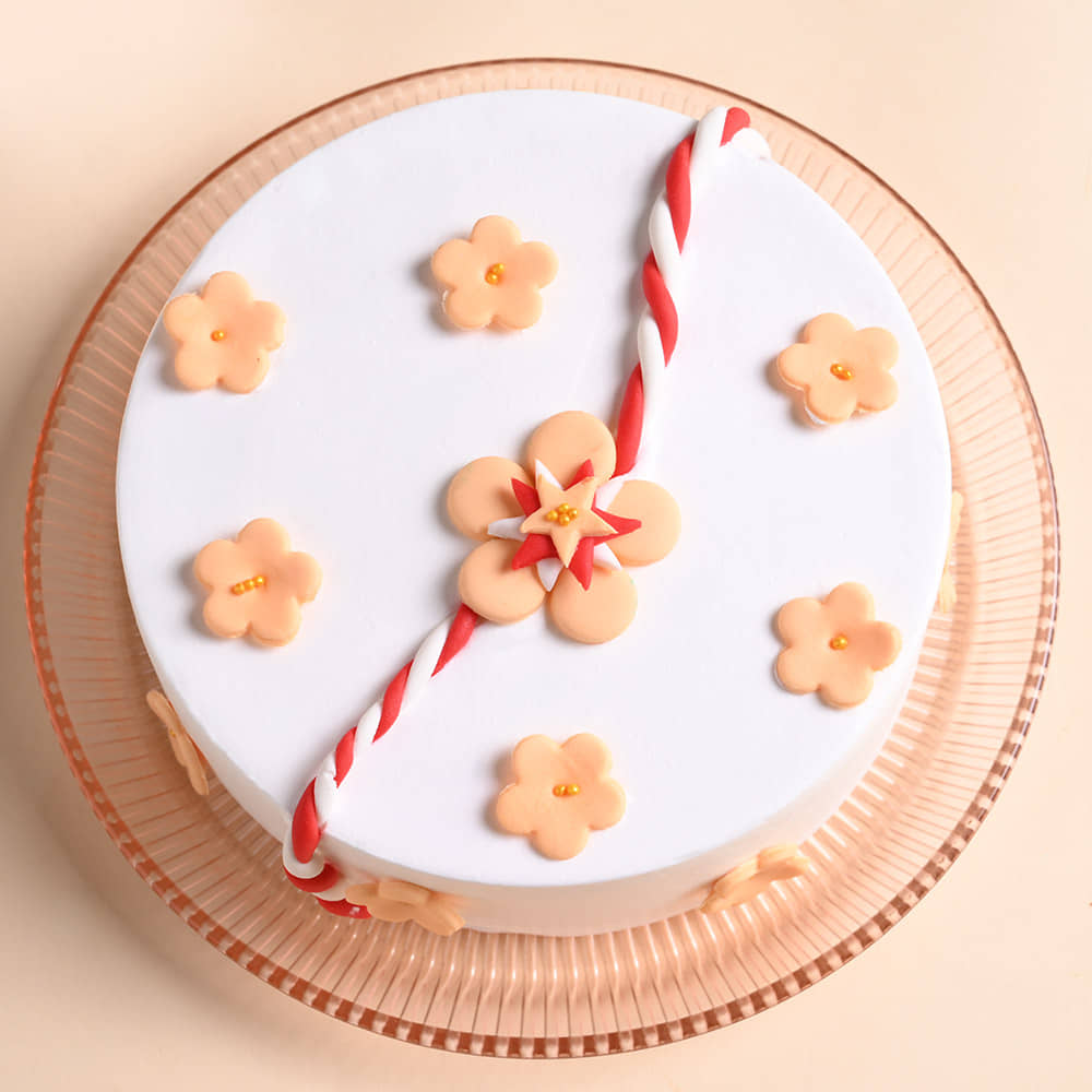 Floral Rakhi Cake With Pearl Rakhi Top View of Pineapple Cake With Rakhi