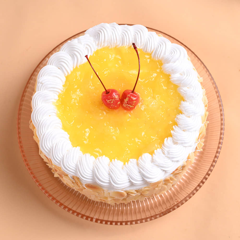 Pineapple Cake With Floral Pearl Rakhi Top View of Pineapple Cake N Floral Rakhi For Brother