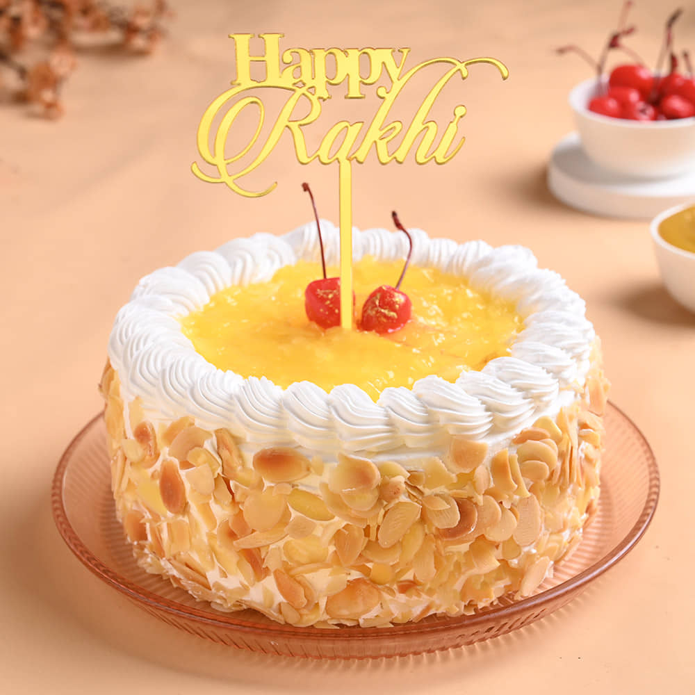 Pineapple Cake With Floral Pearl Rakhi Front View of Pineapple Cake N Floral Rakhi For Brother
