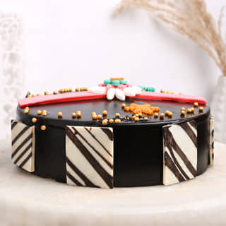 Side View of Raksha Bandhan Chocolate Cake With Rakhi