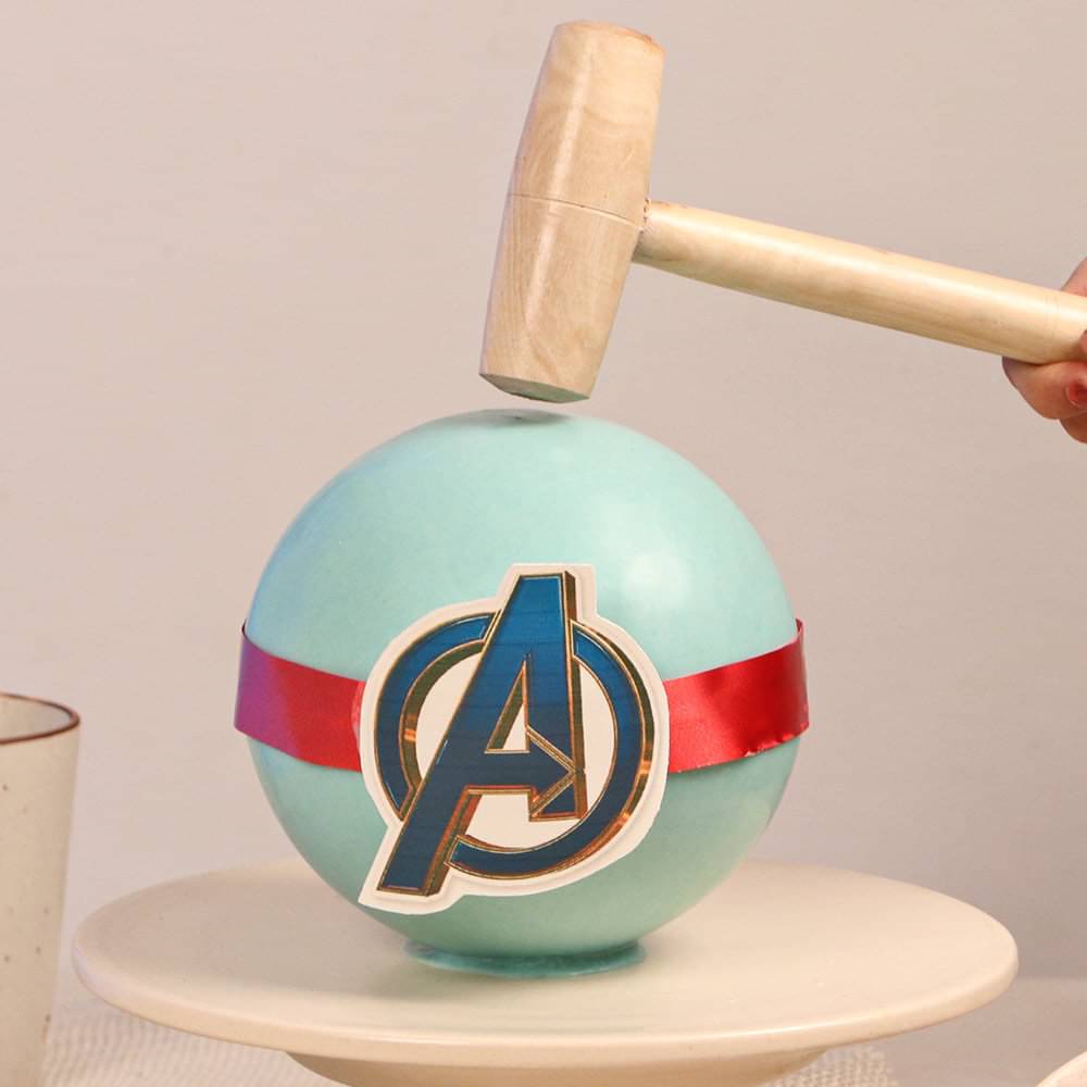 Hammer on Top of Avenger Pineapple Pinata Cake