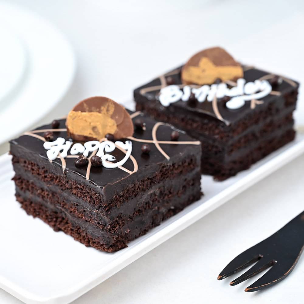 Side View of Set of Two Happy Birthday Pastry