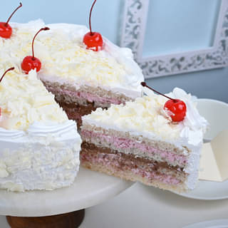 Sliced View of White Paradesia - A White Forest Cake