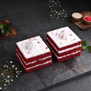 Two Red Velvet Pastries With Peacock Rakhi