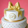  White And Golden Fondant Bow Cake